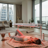Person using a full-body red light therapy panel at home
